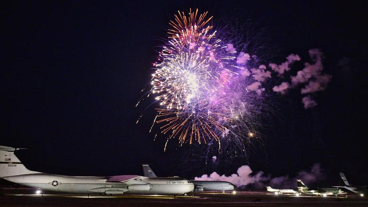 Fireworks blast off in the night sky at the centennial kickoff.