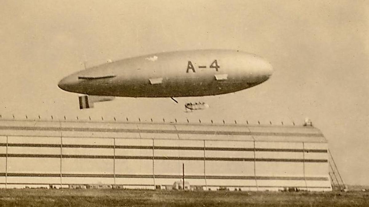 Pictured is Airship A-4 in flight over Scott Field in September 1922 with the Airship Hangar in the background.