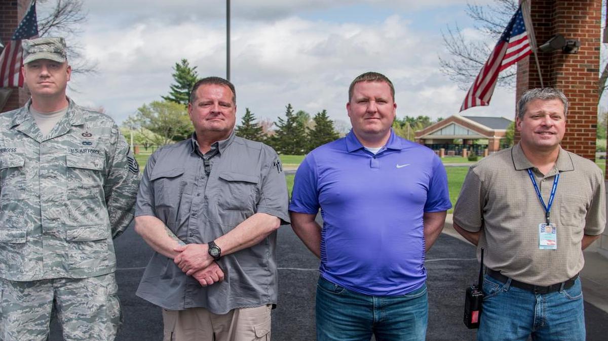 Master Sgt. Michael Burgess, 932nd Air Wing occupational safety manager; Jim Binford, 375th Safety Office occupational safety manager; Anthony Mckee, 375th Safety Office occupational safety manager; and T.J. Miles, 375th Medical Group occupational safety manager, pose for a photo outside of the Scott Event Center. The Team Scott members assisted a man in a vehicle accident on their way home from St. Louis on March 15.