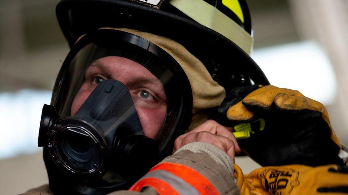 Tech Sgt. Thomas Dunlap, 375th Communications Squadron NCO in charge of radio frequency transmissions, suits up in bunker gear at the O’Fallon Fire Department. Photo by Airman 1st Class Tara Stetler