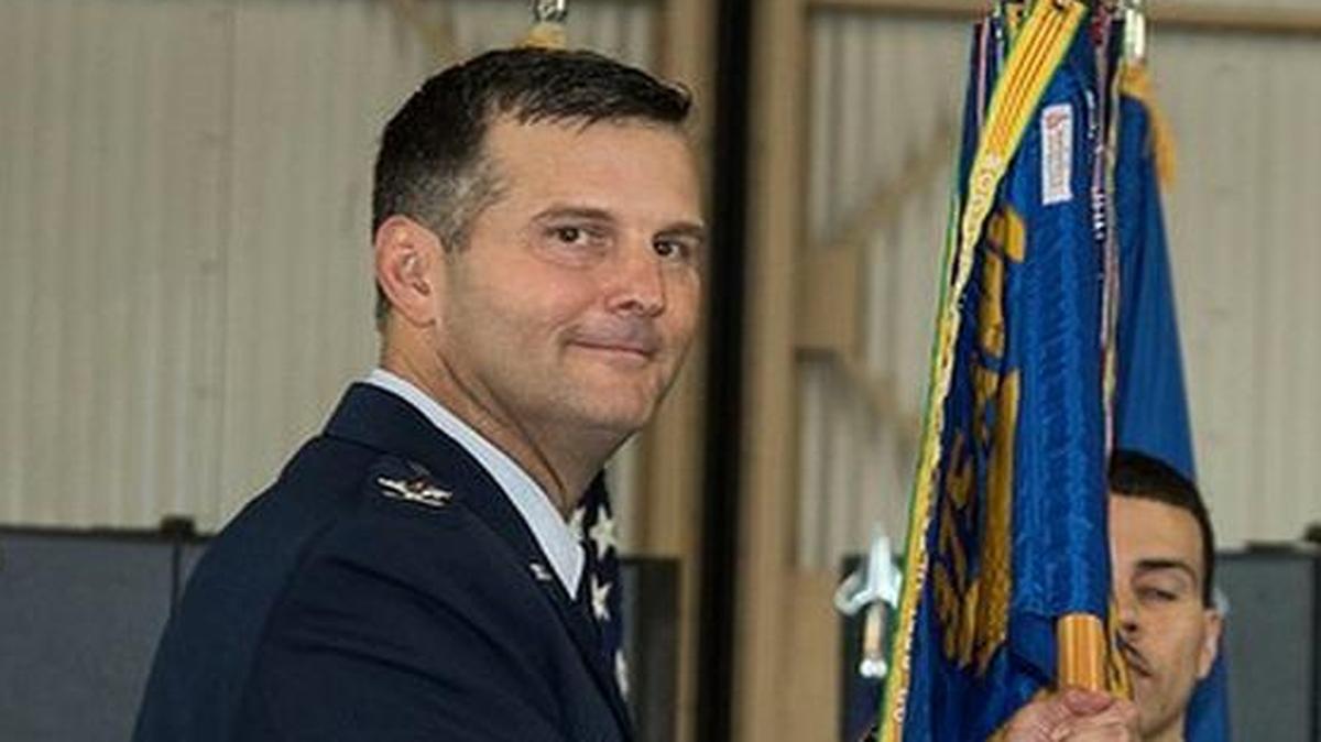Lt. Col. Greg M. Adams receives the guidon from Col. Perry Long, 375th Operations Group commander, as he assumes command of the 457th Airlift Squadron on Sept. 9 at Joint Base Andrews, Md.