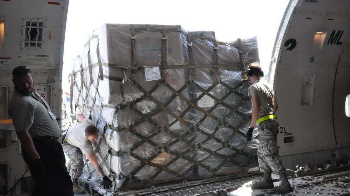 Airmen 1st Class Ryan Adams and Cody Lumley, air freight technicians from the 730th Air Mobility Squadron, offload cargo at Yokota Air Base, Japan, before the aircraft continues onto Paya Lebar Air Base in Singapore. Air Mobility Command sustains 42 en-route locations around the globe through the use of a complex system of channels. Photo by Capt. Krystal Jimenez
