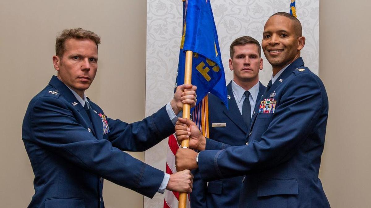 Col. Robert Henderson, 375th Mission Support Group commander, presents the 375th Force Support Squadron guidon to Maj. Harvey Catchings during a change of command ceremony July 9 at Scott Air Force Base. Catchings comes to Scott from the Air Command and Staff College, Maxwell Air Force Base, Alabama.