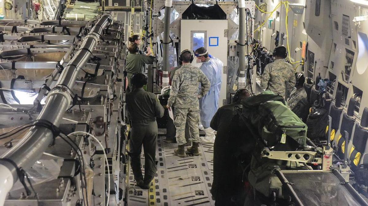 Airmen from the 375th and 628th Aeromedical Evacuation Squadrons out of Scott Air Force Base and Joint Base Charleston, South Carolina, along with medical researchers from Indiana and Nebraska universities conduct Transportation Isolation System training on a flight from Joint Base Charleston to Offutt Air Force Base, Nebraska. The Transport Isolation System, or TIS, is an enclosure the Department of Defense can use to safely transport patients with highly contagious diseases such as Ebola. Photo by Airman 1st Class Joshua R. Maund