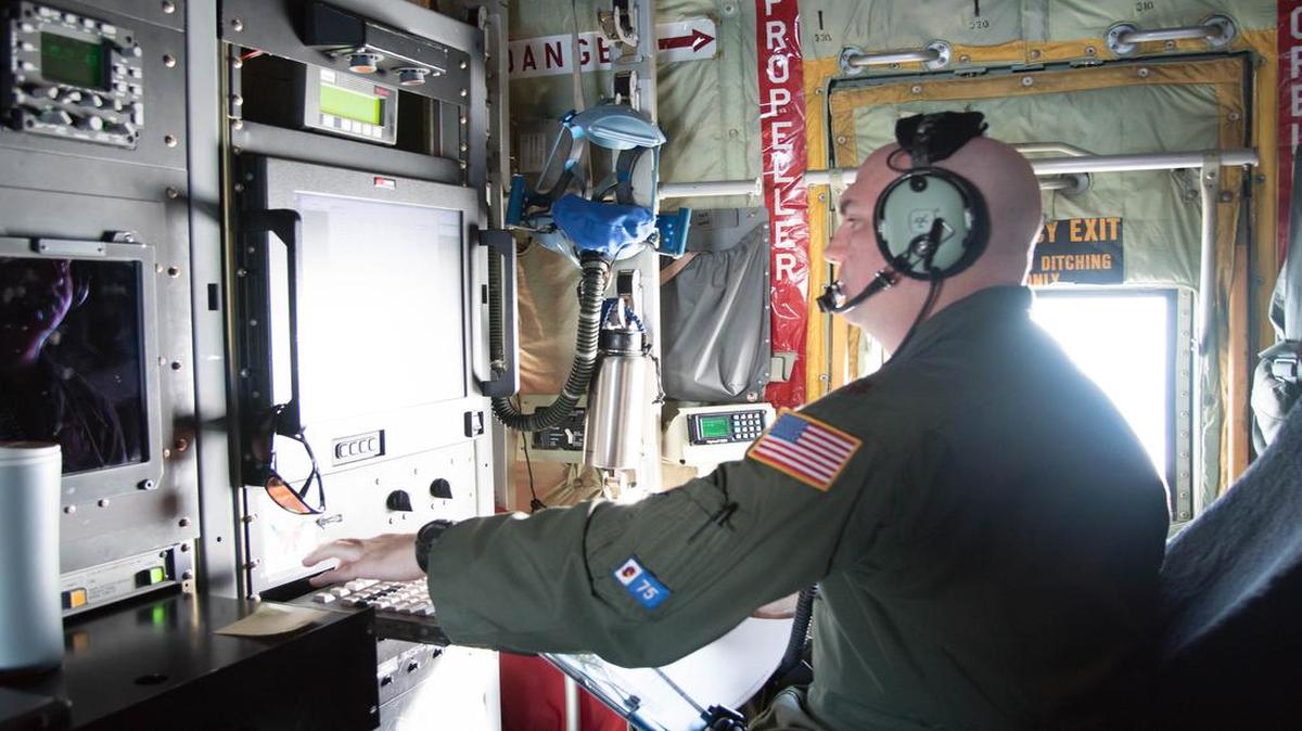 Maj. Tobi Baker, a 53rd Weather Reconnaissance Squadron aerial reconnaissance weather officer, watches the radar and analyzes weather data during a flight into Hurricane Hermine.