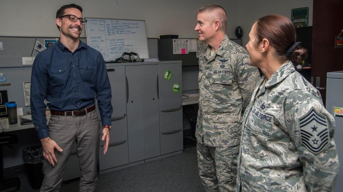 Mike Skrabacz, 375th Air Mobility Wing Information Protection, briefs Col. Chris Buschur, 375th AMW commander, and Chief Master Sgt. Patricia Hickey, 375th AMW command chief, Jan. 8.