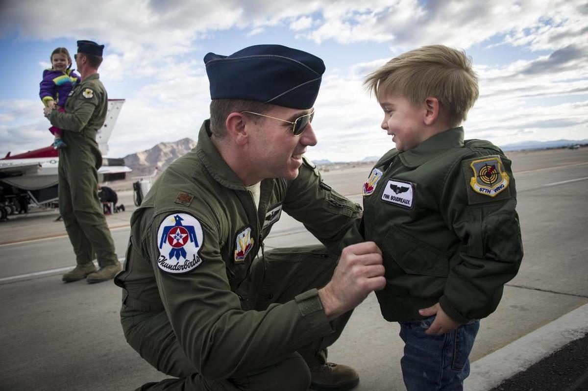 Maj. Joshua Boudreaux, Thunderbird 2, and Maj. Jason Curtis, Thunderbird 5, are greeted by their children after performing their first Delta Formation sortie at Nellis Air Force Base, Nev.