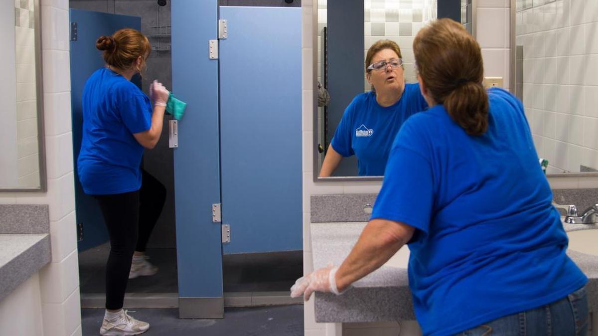 Dawn D., Challenge Unlimited employee, and Cyndi G., Challenge Unlimited supervisor, clean a locker room at the James Gym Aug. 13 on Scott Air Force Base. Scott has partnered with Challenge Unlimited through the Ability One program for 25 years. Photo by Senior Airman Cheyenne Larkin