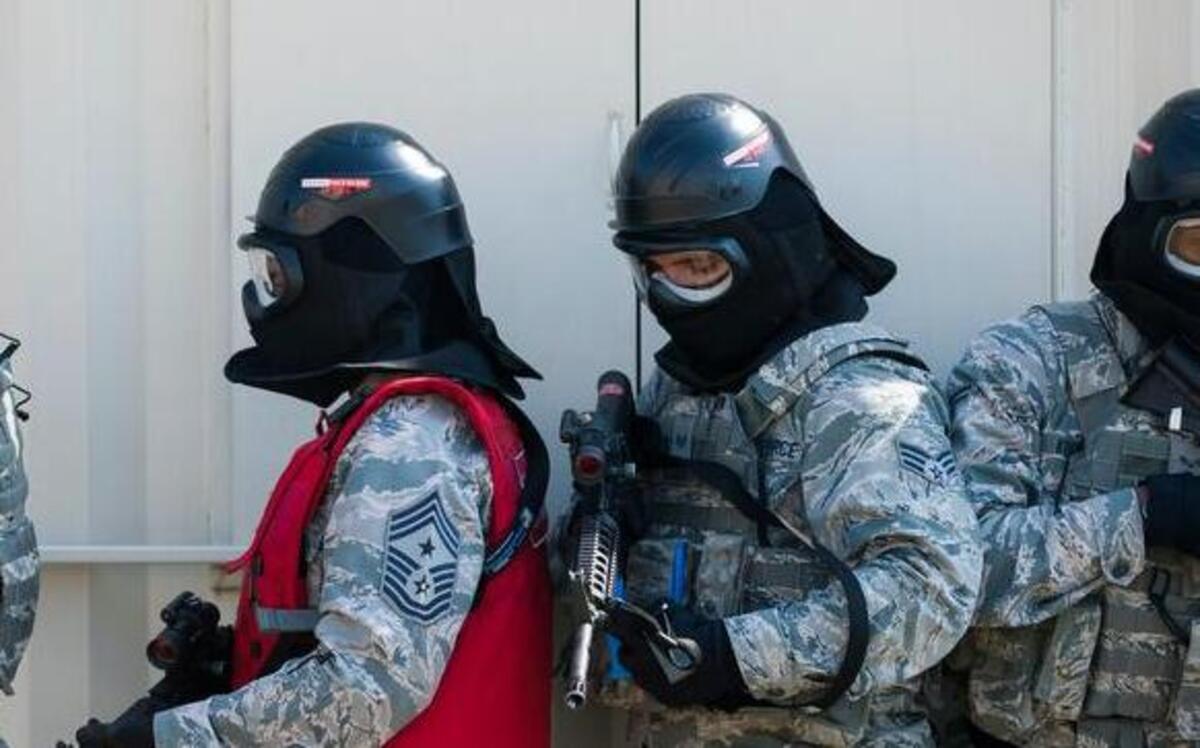 Chief Frey (in the red vest) participates in responding to an active shooter exercise at the 375th SFS’s shoot house, which provides realistic training on a variety of situations.