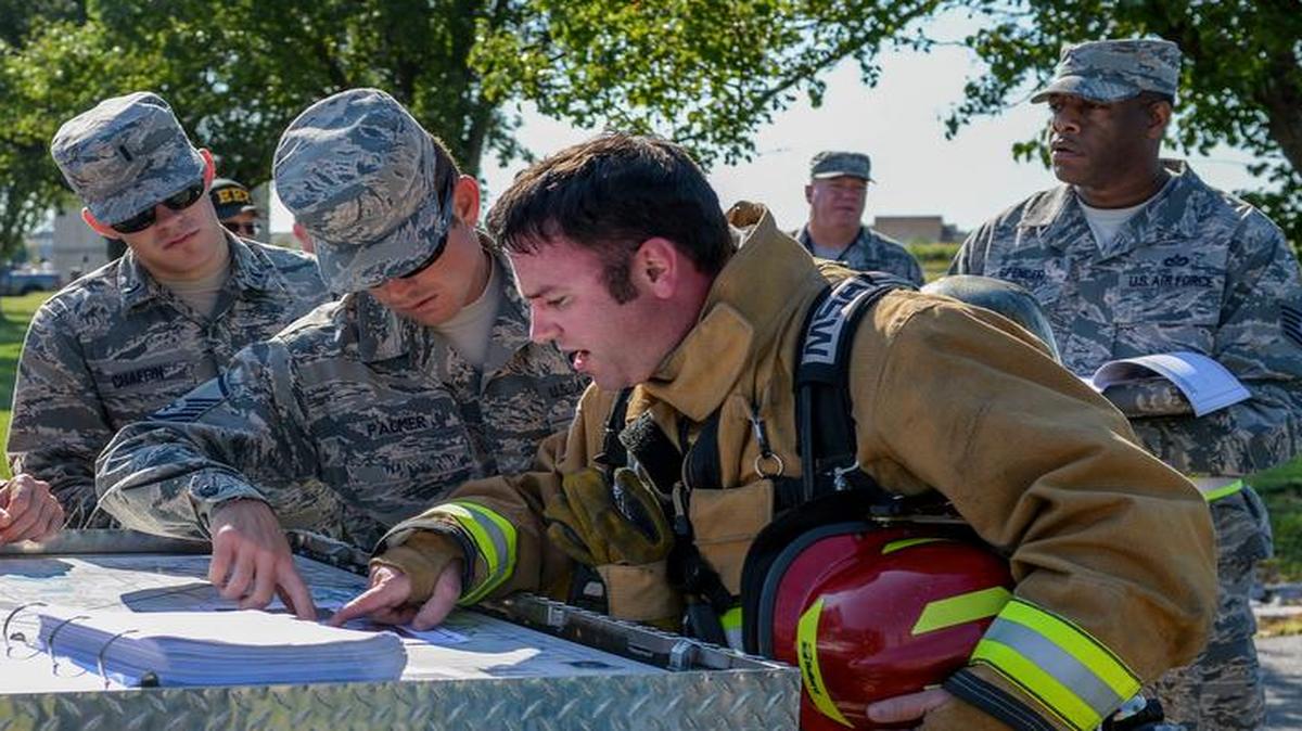 Members of the 375th’s Logistics Readiness Squadron, Civil Engineer Squadron and Wing Inspection Team review a layout of the area during a fuel spill exercise Aug. 24 at Scott AFB. During the exercise, field response teams executed containment, recovery and mitigation of the incident. The 375th Air Mobility Wing held the exercise to test requirements and procedures outlined in the Installation Emergency Management Plan.