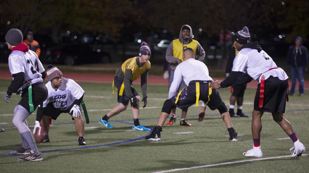 Airmen with the 635th Supply Chain Operations Group flag football team prepare to run a play during the 2018 Intramural Flag Football Championship game Nov. 8 at the James Gym track field on Scott AFB. The SCOG beat the 375th Force Support Squadron 32-20. Photo by Airman 1st Class Isaiah Gonzalez