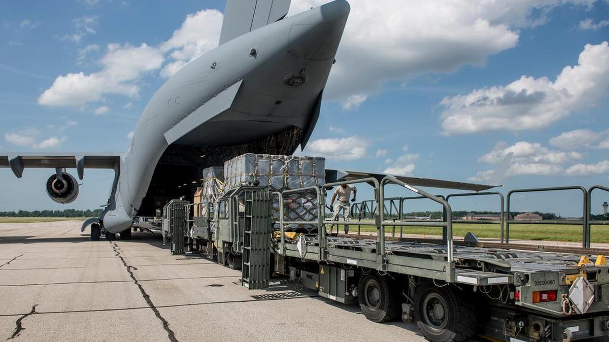 Airmen with the 375th Logistics Readiness Squadron unload pallets of aeromedical evacuation equipment from a C-17 Globemaster III that arrived at Scott Air Force Base.