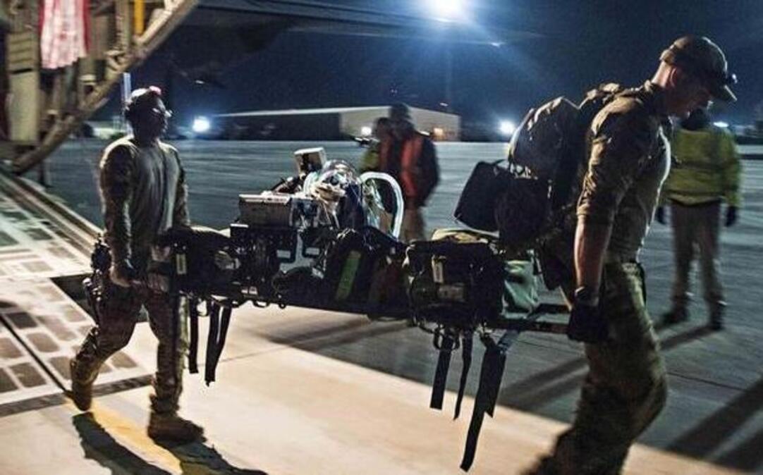 Staff Sgt. Errington Neysmith and Senior Airman Joshua O’Sullivan carry respirator equipment when picking up a patient from the Kandahar Regional Military Hospital, Kandahar Airfield, Afghanistan, Feb. 22. Neysmith and O’Sullivan are critical care respiratory therapists deployed from Scott as part of the 455th Aeromedical Evacuation Squadron.