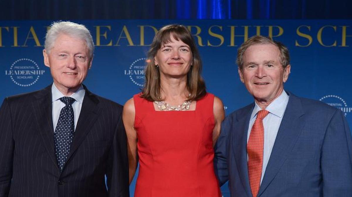 Kathy Wever, NGA Support Team Chief at U.S. Transportation Command at Scott Air Force Base, is pictured with former Presidents Bill Clinton and George H.W. Bush as part of the 2016 Presidential Leadership Scholars program. Wever was in the PLS class of 2016.