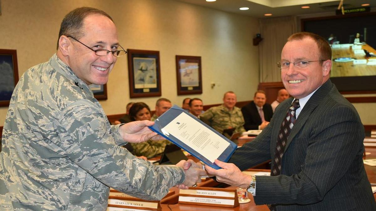 Lt. Gen. Lee K. Levy II, Air Force Sustainment Center commander, presents Jeffrey Allen, AFSC executive director, with a letter from Gen. Ellen Pawlikowski, Air Force Materiel Command commander, congratulating him on being a recipient of the 2016 Presidential Rank Award of Meritorious Executive. The award will be presented by the President of the United States in a formal ceremony later this year.