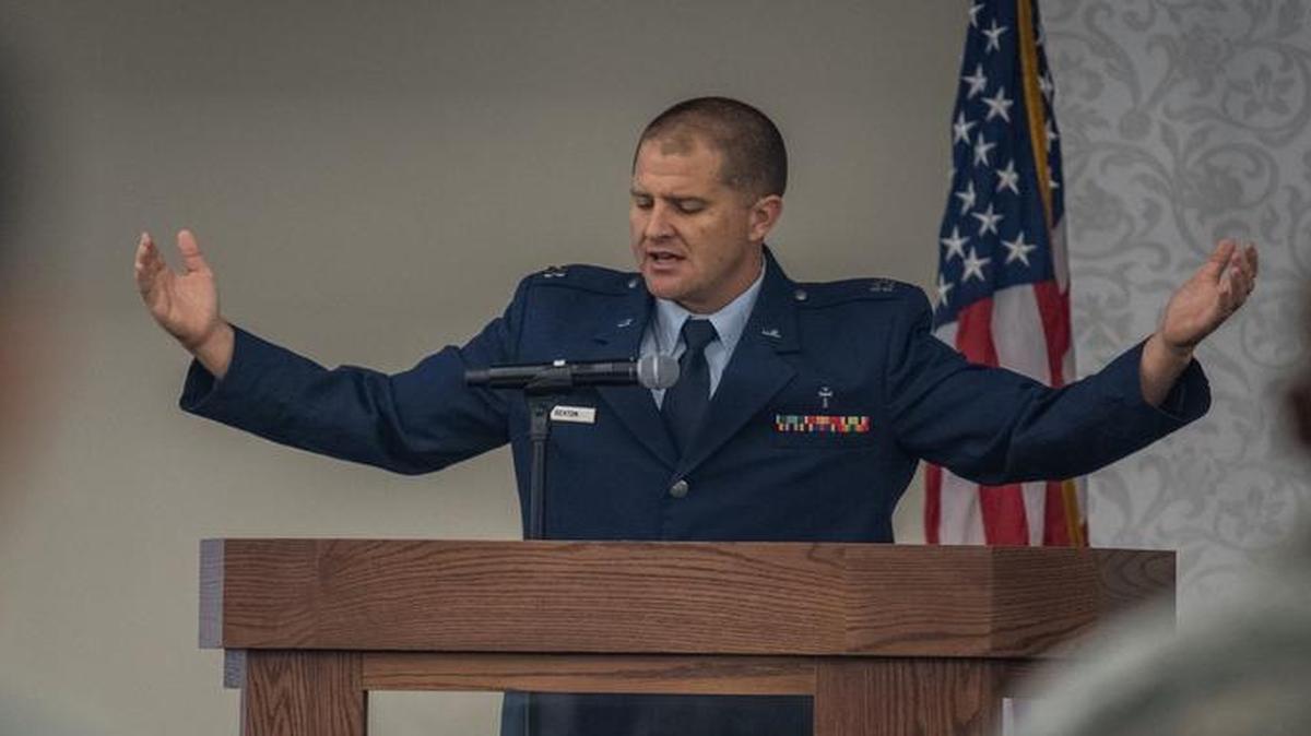 Chaplain (Capt.) Jeremy Sexton, 375th Air Mobility Wing chaplain services, gives the invocation during the third annual Spiritual Resiliency Breakfast, which took place recently at the Scott Event Center. “The Spiritual Resiliency Breakfast reminds leadership of the importance of faith and religion to the mission and to the wellness of our people,” said 375th AMW chaplain (Lt. Col.) James Richey. Sexton welcomed everyone to join him in prayer, saying this for his opening of the invocation, “I’m required to pray according to my faith tradition as a Christian; I invite you to pray according to your own tradition.”