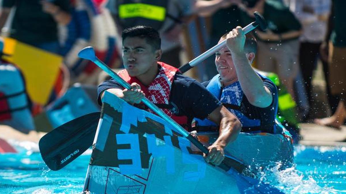 Members of the 345th Recruiting Squadron vigorously paddle ahead during the boat regatta Aug. 4.