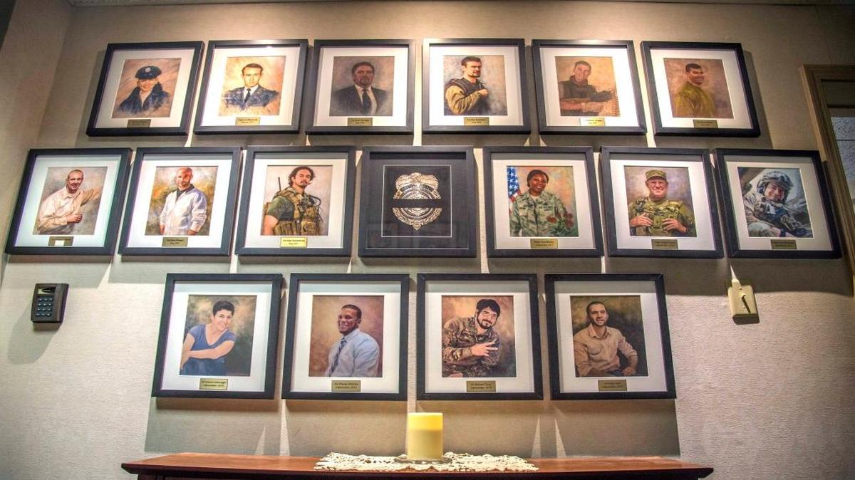 The illustrations of six fallen heroes killed Dec. 21, 2015 by a suicide bomber near Bagram Air Field, Afghanistan are displayed at the Air Force Office of Special Investigation headquarters at Scott. The four OSI special agents, Micahel A. Cinco, Chester J. McBride, Peter W. Taub and Adrianna M. Vorderbruggen; and two Security Forces defenders, now honorary special agents, Tech. Sgt. Joseph G. Lemm and Staff Sgt. Louis M. Bonacasa, had their Hall of Heroes portraits added to the wall alongside 10 previous fallen heroes.