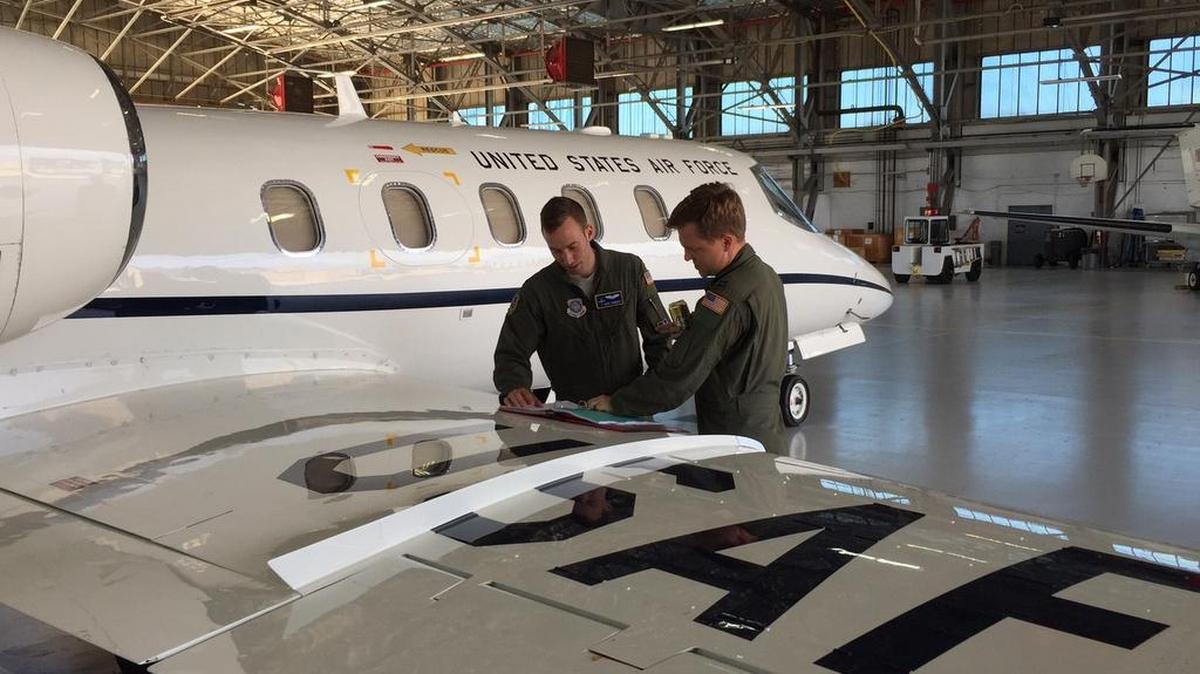 Capts. Michael Chimienti and Jonathan Rember, 457th Airlift Squadron, review aircraft forms prior to a mission. The 457th AS is a geographically separated unit located at Joint Base Andrews, Md., and is responsible to provide safe and reliable airlift support for senior leaders.