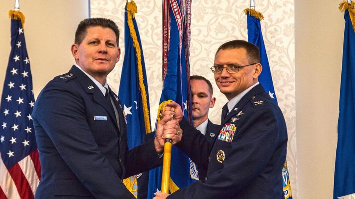 Maj. Gen. David D. Thompson, Air Force Space Command vice commander, presents the Air Force Network Integration Center flag to Col. Douglas Dudley signifying the start of his command of AFNIC Feb. 6.