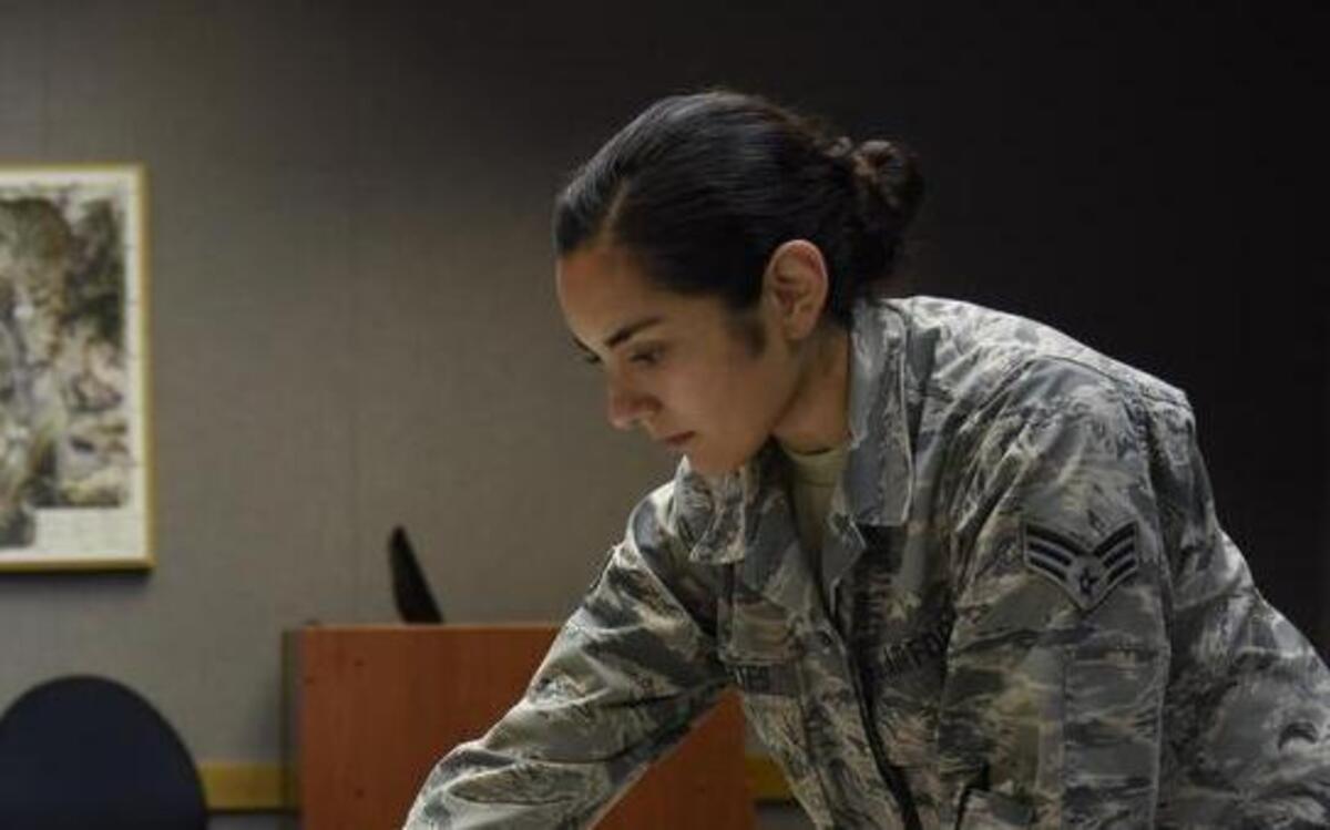 Senior Airman Brittany Fuentes, a collection requirements manager at Air Mobility Command, briefs information regarding a mobility mission to other analysts at Scott Air Force Base. Fuentes is one of the Air Force’s 12 Outstanding Airmen of the Year. She will represent Air Mobility Command at the Air Force Association convention this month.