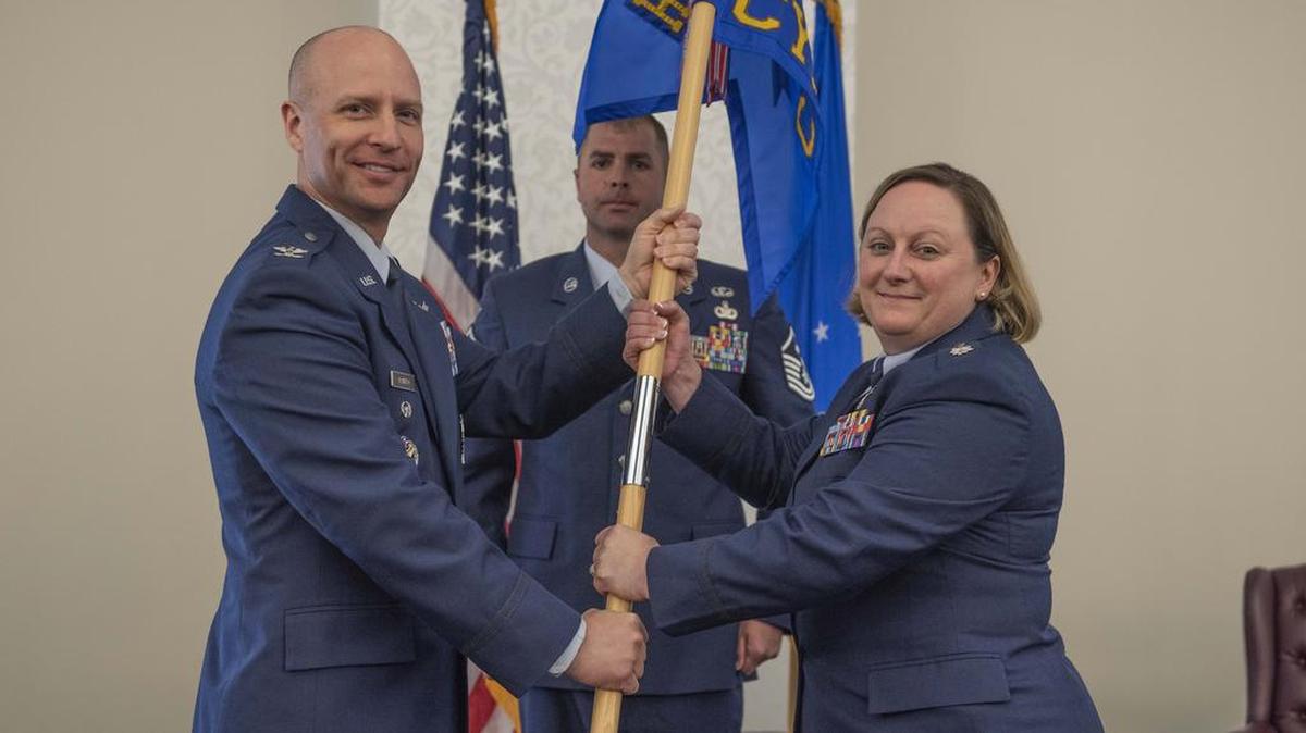 Col. Robert Pavelko, deputy director of Integrated Air, Space, Cyberspace and Intelligence, Surveillance and Reconnaissance Operations at Peterson AFB, Colorado, presents the Cyberspace Support Squadron guidon to Lt. Col. Tassika Davis during a change of command ceremony July 13 at Scott Air Force Base.