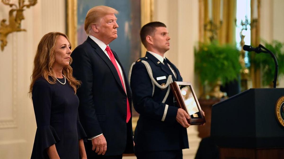 Valerie Nessel, the spouse of Tech. Sgt. John Chapman, stands as the citation is read before receiving the Medal of Honor from President Donald J. Trump during a ceremony at the White House in Washington, D.C., Aug. 22. Chapman was posthumously awarded the Medal of Honor for actions on Takur Ghar mountain in Afghanistan on March 4, 2002. Photo by Wayne A. Clark