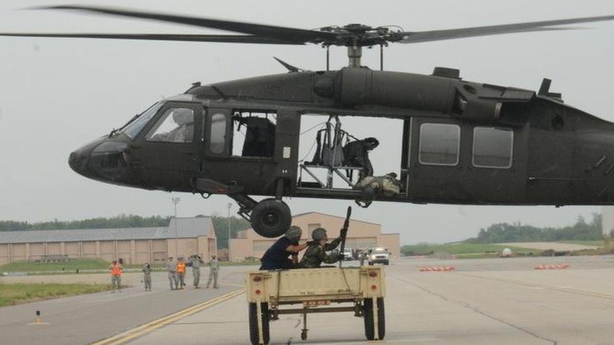 Service members working with U.S Transportation Command and members of the Civil Air Patrol hook a trailer to a UH-60 Black Hawk during a training mission at Scott AFB. USTRANSCOM conducts training missions to stay proficient at various air operations as well as build a rapport with local emergency services.