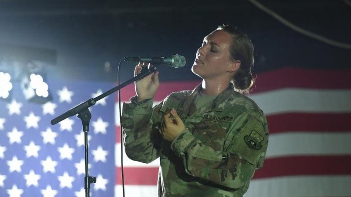 Airman 1st Class Anneke Bentley, vocalist with the Band of Mid-America, performs for Airmen of the 380th Air Expeditionary Wing at Al Dhafra Air Base, United Arab Emirates.