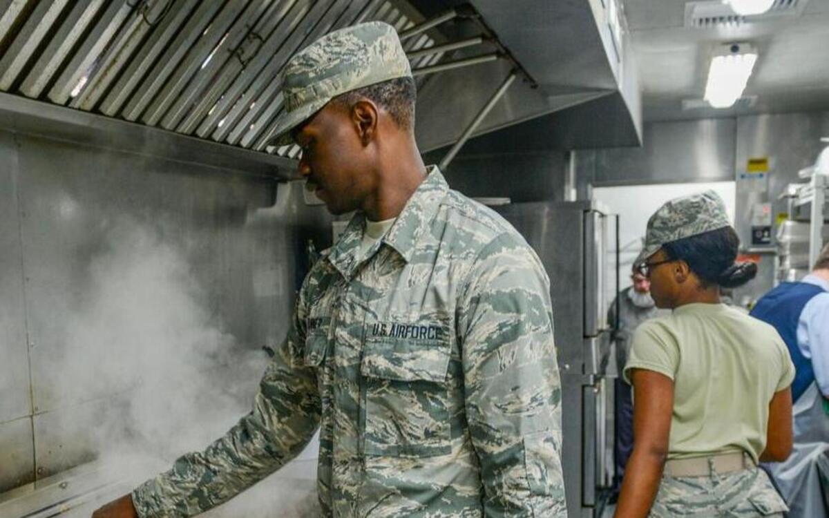 Airman Taijha Turner, 375th Force Support Squadron cook, cleans the grill inside the portable trailer at the Nightingale Dining Facility at Scott Air Force Base. The Nightingale Dining Facility has continued its operations while also renovating the building, which are focused on improving the safety of the facility.