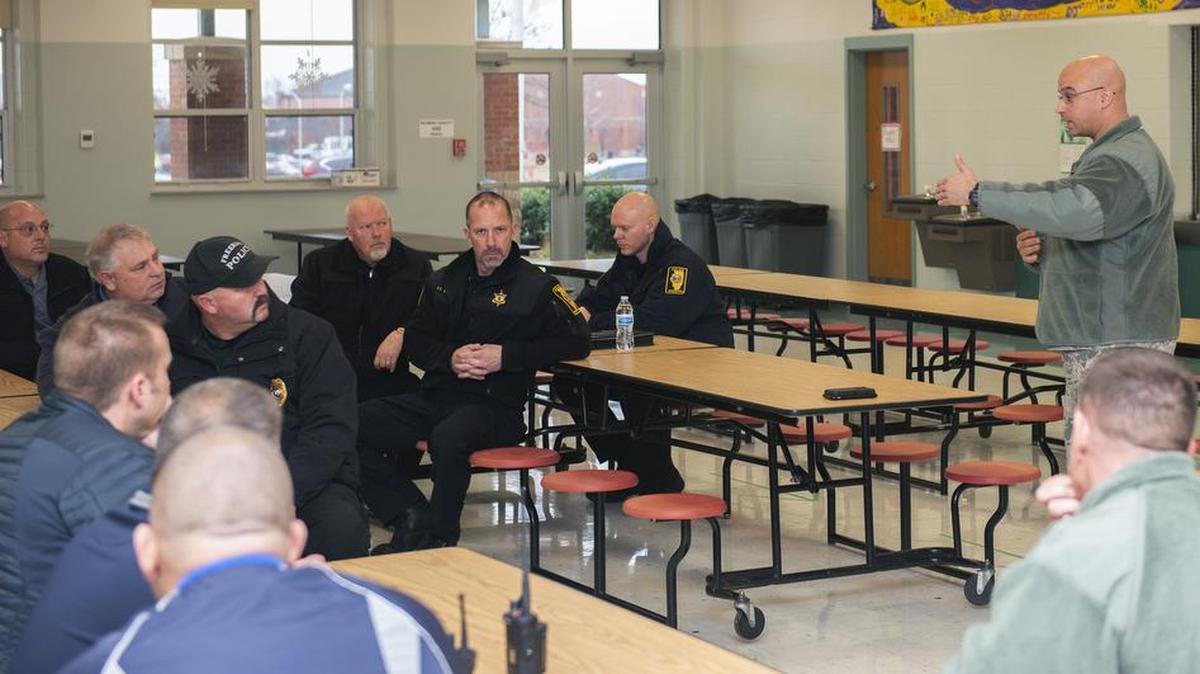 Lt. Col. Yon Dugger, 375th Security Forces Squadron commander, speaks to members of the St. Clair County Police Department and Scott Elementary School on Dec. 21 at Scott Air Force Base. The organizations met to discuss base procedures in the event of an active shooter incident to include a walkthrough of the school to locate all possible exit points and potential safe rooms in the building.