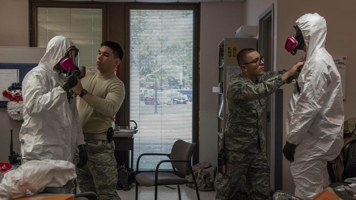 Bioenvironmental engineering technicians with the 375th Aerospace Medicine Squadron prepare protective suits during a training exercise Nov. 29. Level C level of protection is used in events where the concentration and type of airborne substance is known and the criteria for using an air purifying respirator are met. Photo by Senior Airman Daniel Garcia