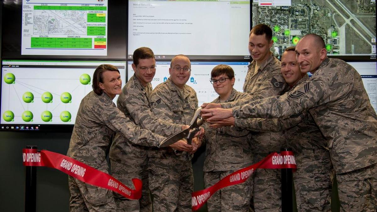 Col. Leslie Maher, 375th Air Mobility Wing commander, and the official party cut the ribbon at the grand opening of the Cyber Operations Center Aug. 23 on Scott Air Force Base. The CyOC will act as a centralized reporting agency for over 14,000 users on Scott AFB, including its vital mission partners. Photo by Airman 1st Class Nathaniel Hudson