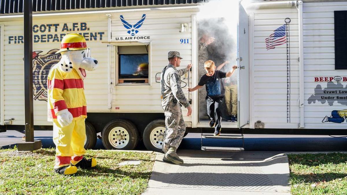 Children from the Scott Air Force Base Youth Center exit the 375th Civil Engineer Squadron’s “smoker” during a presentation as part of 2018 National Fire Prevention Week. The smoker simulates how quickly a room can fill up with smoke and allows the opportunity to practice getting low and finding an exit during a fire. Throughout the week, the fire department visited the Child Development Centers, Scott Elementary School, the Scott Youth Center, hosted a puppet show at the base library, and held an open house and Fall Festival at Fire Station 2 on base. Photo by Airman 1st Class Chad Gorecki