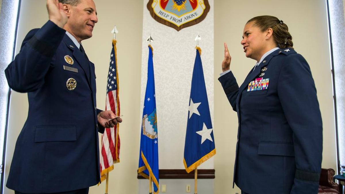 Lt. Gen. Lee K. Levy II, Air Force Sustainment Center Commander, swears in Brig. Gen. Linda Hurry, 635th Supply Chain Operations Wing Commander, during her promotion ceremony June 30. Hurry stressed that her success was a team effort and gave thanks to her mentors and family members that attended: her two sons, Ryan and Aaron; daughter, Jordyn; parents, Hank and Sonja; brother, U.S. Army Lt. Col. Mare Washburn; and aunts, Diane and Yvonne Washburn.