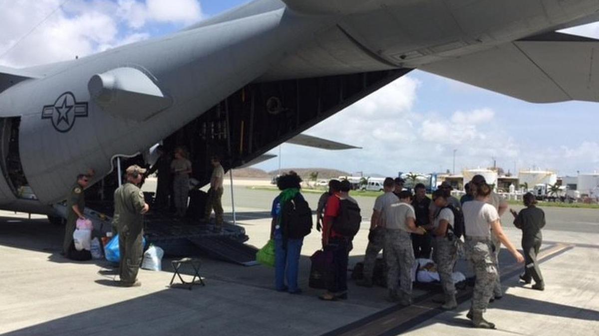 Team Scott members load a patient onto an aircraft during their mission in St. Croix, U.S. Virgin Islands. Enroute Patient Staging System team members were on the island from Sept. 28-Nov. 12 evacuating hospital patients due to severe damage from Hurricane Maria.