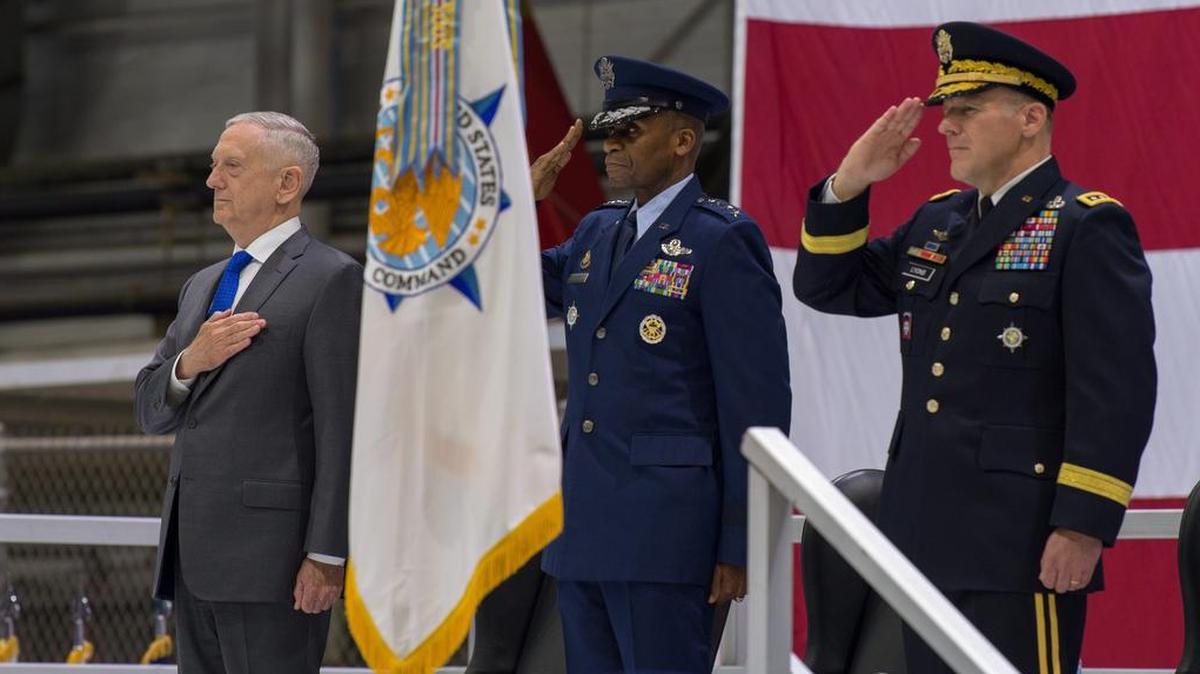 Secretary of Defense James N. Mattis, Air Force Gen. Darren W. McDew, and Army Gen. Stephen R. Lyons pay respect to the colors during the U.S. Transportation Command change of command ceremony Aug. 24 on Scott Air Force Base. Lyons is the first Army officer to lead the command since it was established 31 years ago. USTRANSCOM is a global combatant command and transportation provider for the Department of Defense. The command moves, sustains the force and operates the Joint Deployment and Distribution Enterprise. USTRANSCOM provides the President options to build combat power and deliver national objectives at the time and place of his choosing. Photo by Tech. Sgt. Paul Villanueva II