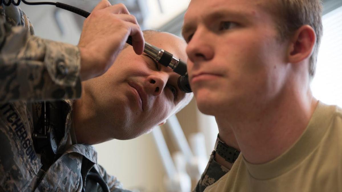 Capt. Brett Hutcherson, 375th Medical Operations Squadron medicine faculty physician, examines a patient’s inner ear, at St. Elizabeth’s Hospital in O’Fallon. The Defense Health Agency assumed responsibility for the administration and management of healthcare at all military medical treatment facilities through a phased approached effective Oct. 1. Photo by Airman 1st Class Tara Stetler