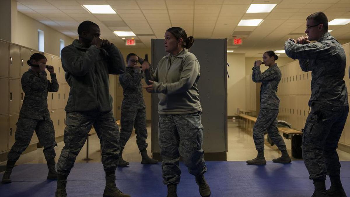 Tech. Sgt. Alexa Ormsby, 375th Security Forces Squadron operations NCO, instructs students on the proper stance for baton strikes during a practical training session Nov. 19 at Scott Air Force Base. Every security forces member must demonstrate proper technique during a live training scenario before being certified on the baton. Photo by Senior Airman Daniel Garcia