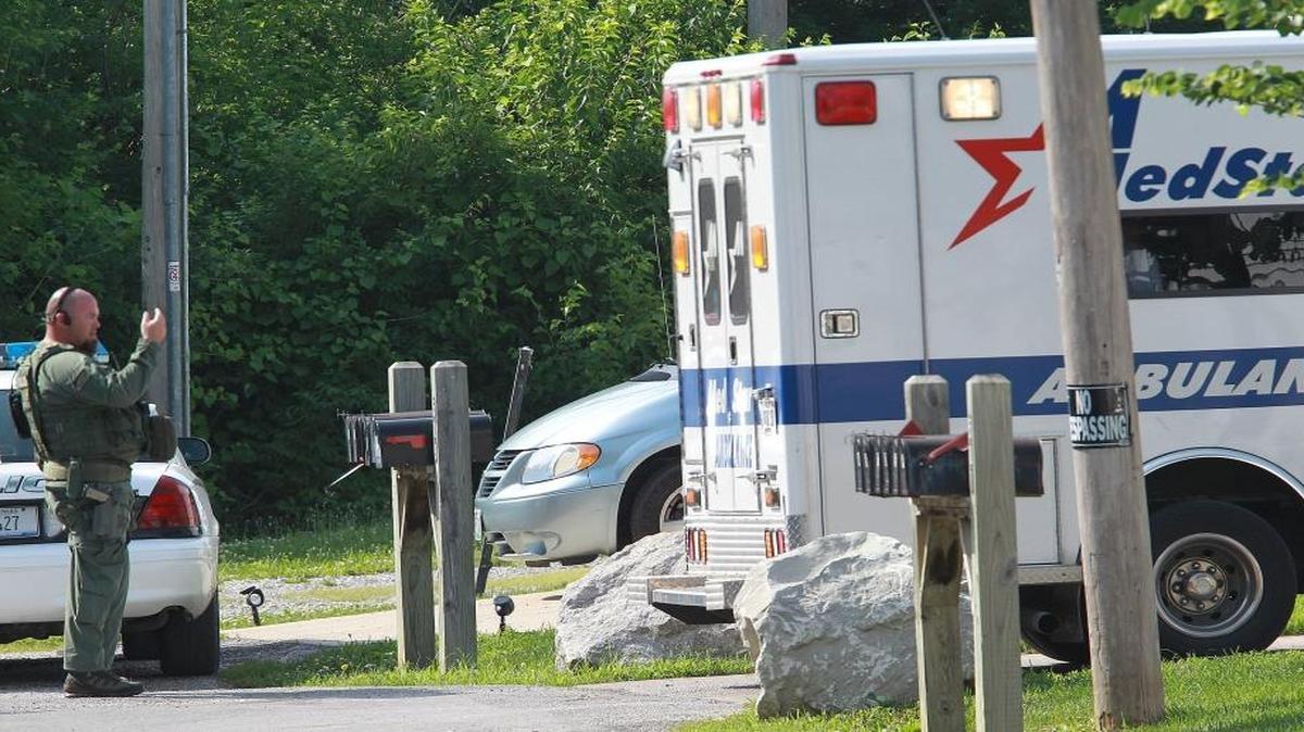 In this file photo, a police officer guides a MedStar ambulance as it backs down a driveway in Dupo.