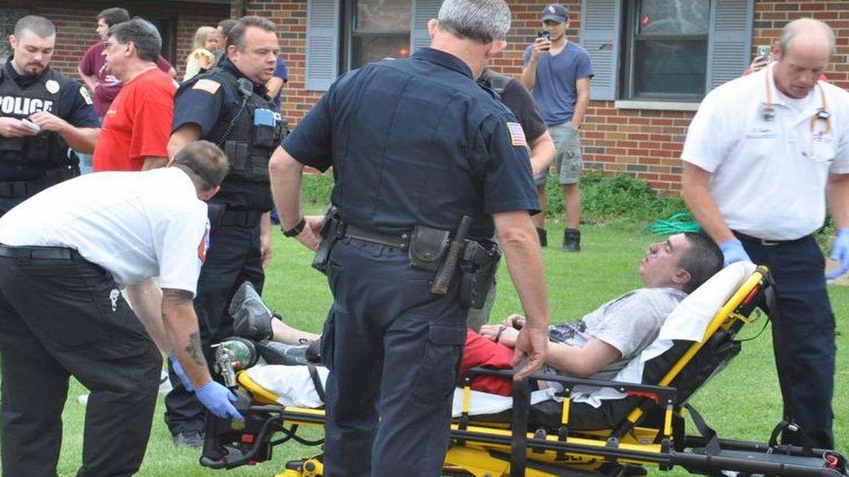
Paramedics tend to Paul H. Benavidez, II, 23, after a neighbor pulled him out of his burning apartment on Lakeshore Drive in Belleville on Aug. 5.
