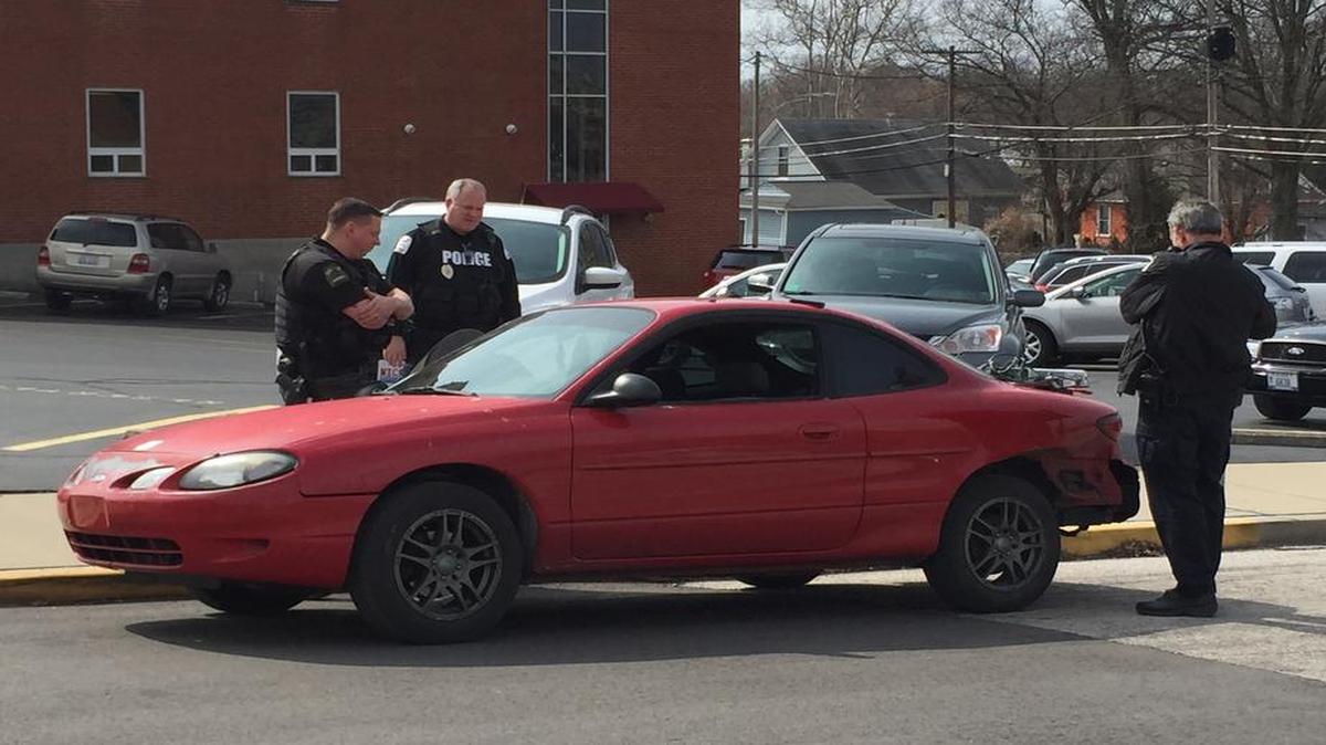 A man in a Ford ZX2 is interviewed by police after a short high-speed chase Monday in downtown Belleville.