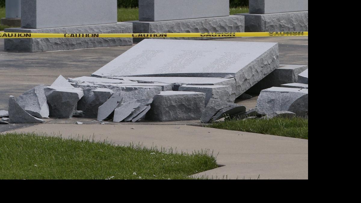 
Stone tablets containing names of military veterans lie crumbled at the O’Fallon City Veteran’s Memorial Monday afternoon. Police are investigating whether vandals or strong winds from recent storms knocked the tablets over.
