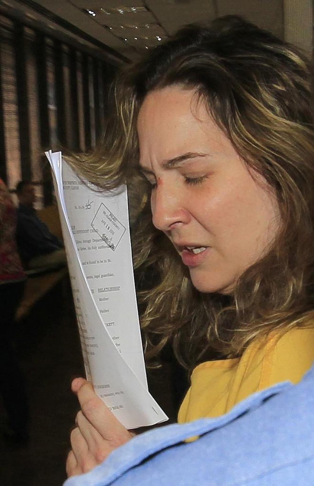 In this April 2017 photo, Mary Lockett turns as she enters the hallway where the family court courtroom is located. She appeared in a hearing there prior to her arraignment in a different courtroom for the first-degree murder of her daughter Emily Rose Perrin by suffocation.