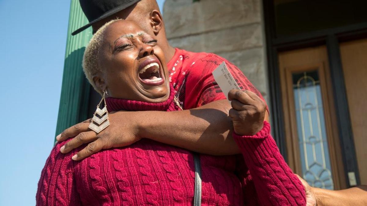 Teresa Jenkins is comforted Sunday by her boyfriend on the porch of her apartment as she talks about her daughter, Kenneka Jenkins, in Chicago.