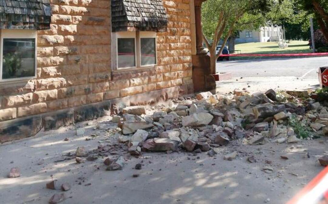 Sandstone bricks from the side of the historic Pawnee County Bank litter the sidewalk after an early morning earthquake in Pawnee, Oka., on Saturday. The United States Geological Survey said a 5.6 magnitude earthquake happened Saturday morning in north-central Oklahoma, on the fringe of an area where regulators had stepped in to limit wastewater disposal. That temblor matches a November 2011 quake in the same region.