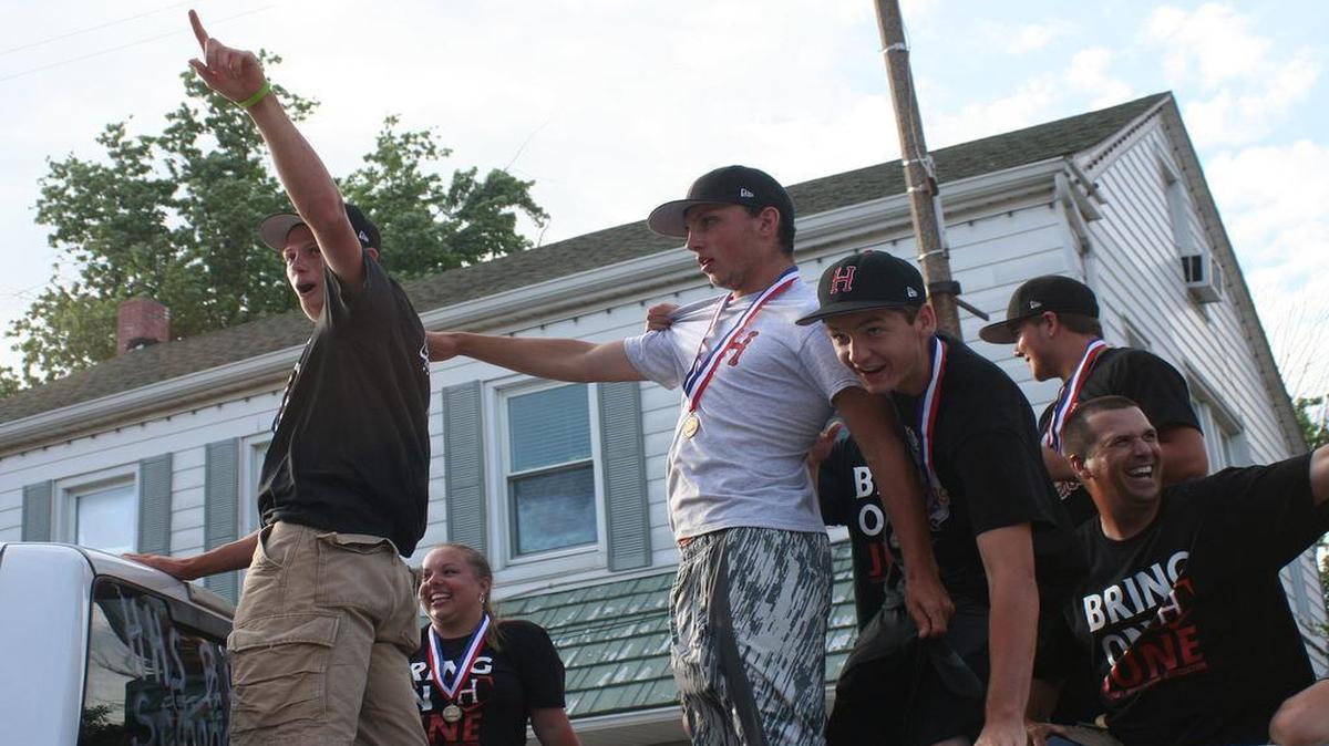 
Highland High School baseball players and coaches ride in a victory parade Saturday after having won the Class 3A IHSA baseball state title earlier in the day. Highland defeated Nazareth Academy 7-6 at Silver Cross Field in Joliet to win the program’s second state title. From left are Tyler Kimmle, trainer Erin Hoepfner, Pete Baumgartner, Jarrett Dubach, Jordan Smith, and assistant coach Sam Weber.
