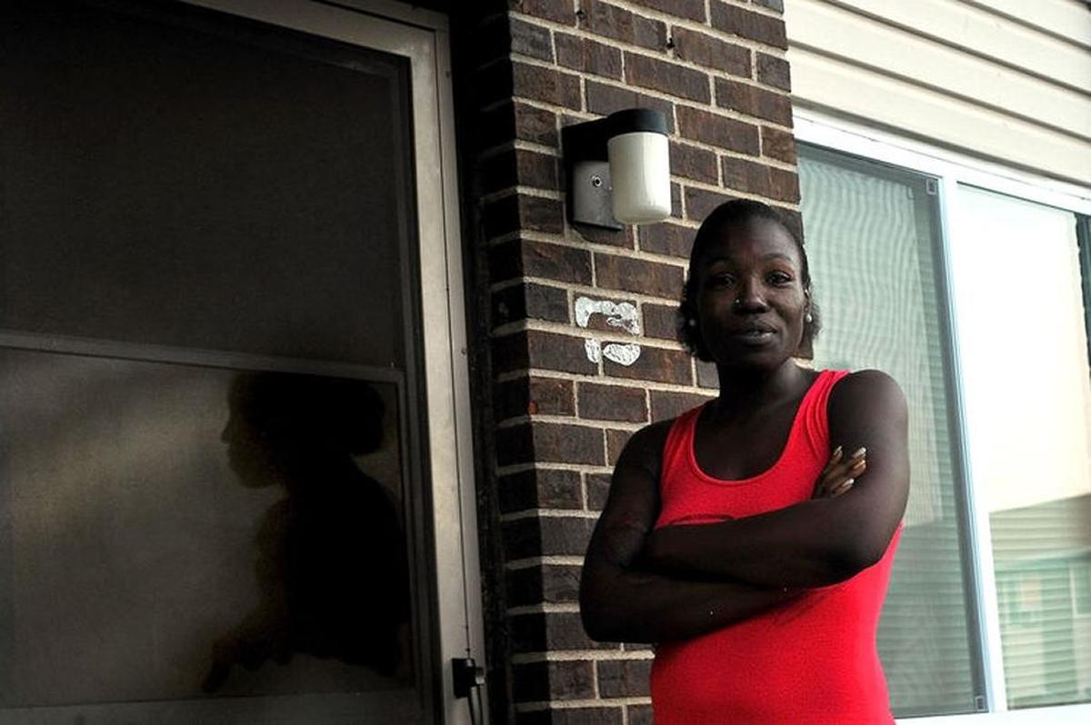 Tamara Moran poses outside her apartment at the Norman Owens Apartments in East St. Louis.