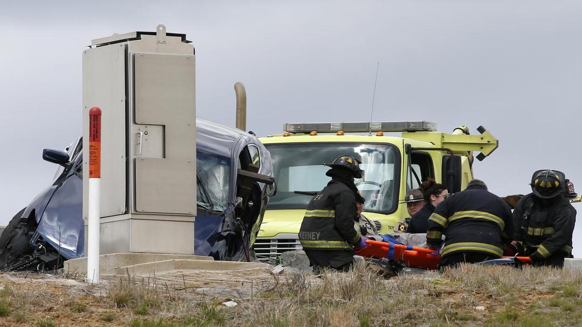 Emergency workers remove a person from a crashed vehicle on Interstate 64 near Illinois Route 3 on Thursday afternoon.