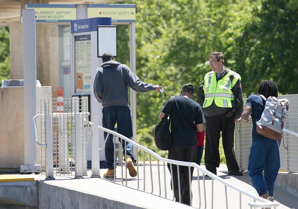 A Metro security guard checks passes and tickets at the Fairview Heights MetroLink station.